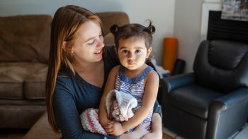 mother with toddler looking serious-1267558400