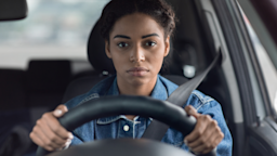 Woman at steering wheel looking very out of it while driving.
Prostock-Studio/iStock via Getty Images