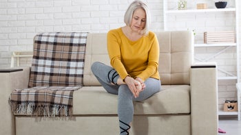 Dermatology: sitting on couch examining foot 1183976330