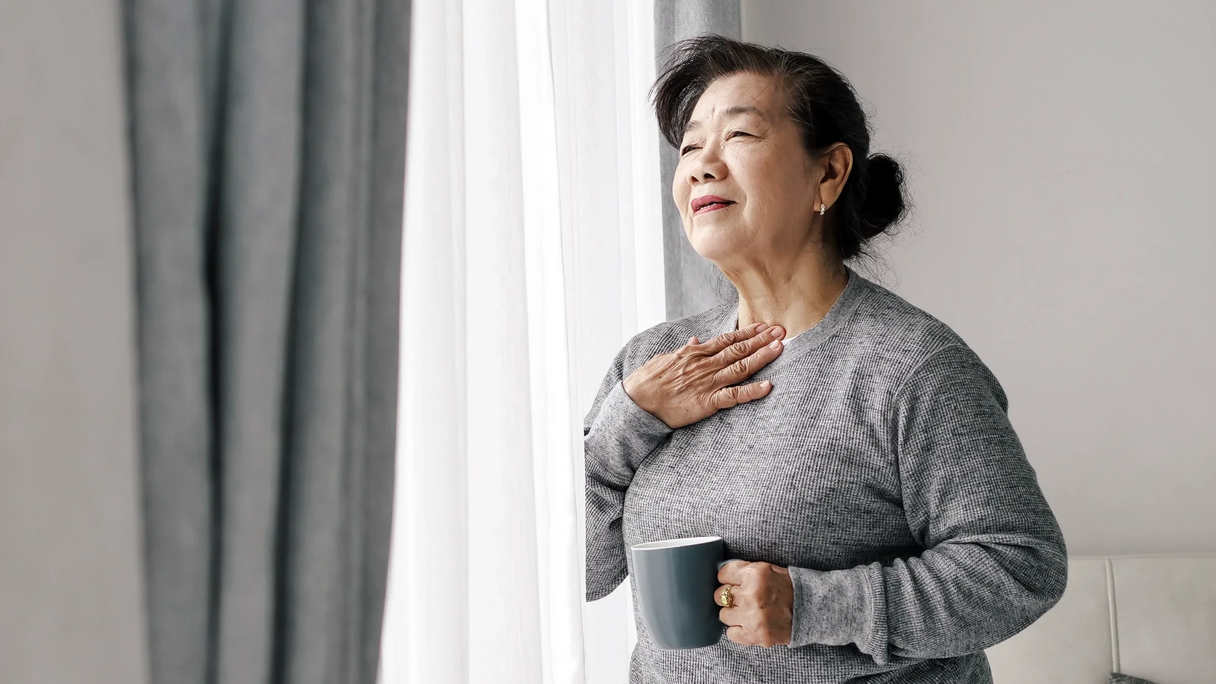 A woman takes a deep breath.