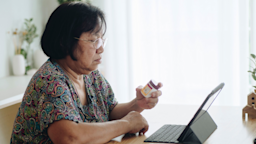 Senior woman with digital tablet checking prescription label in living room at home.
staticnak1983/E+ Getty Images 
