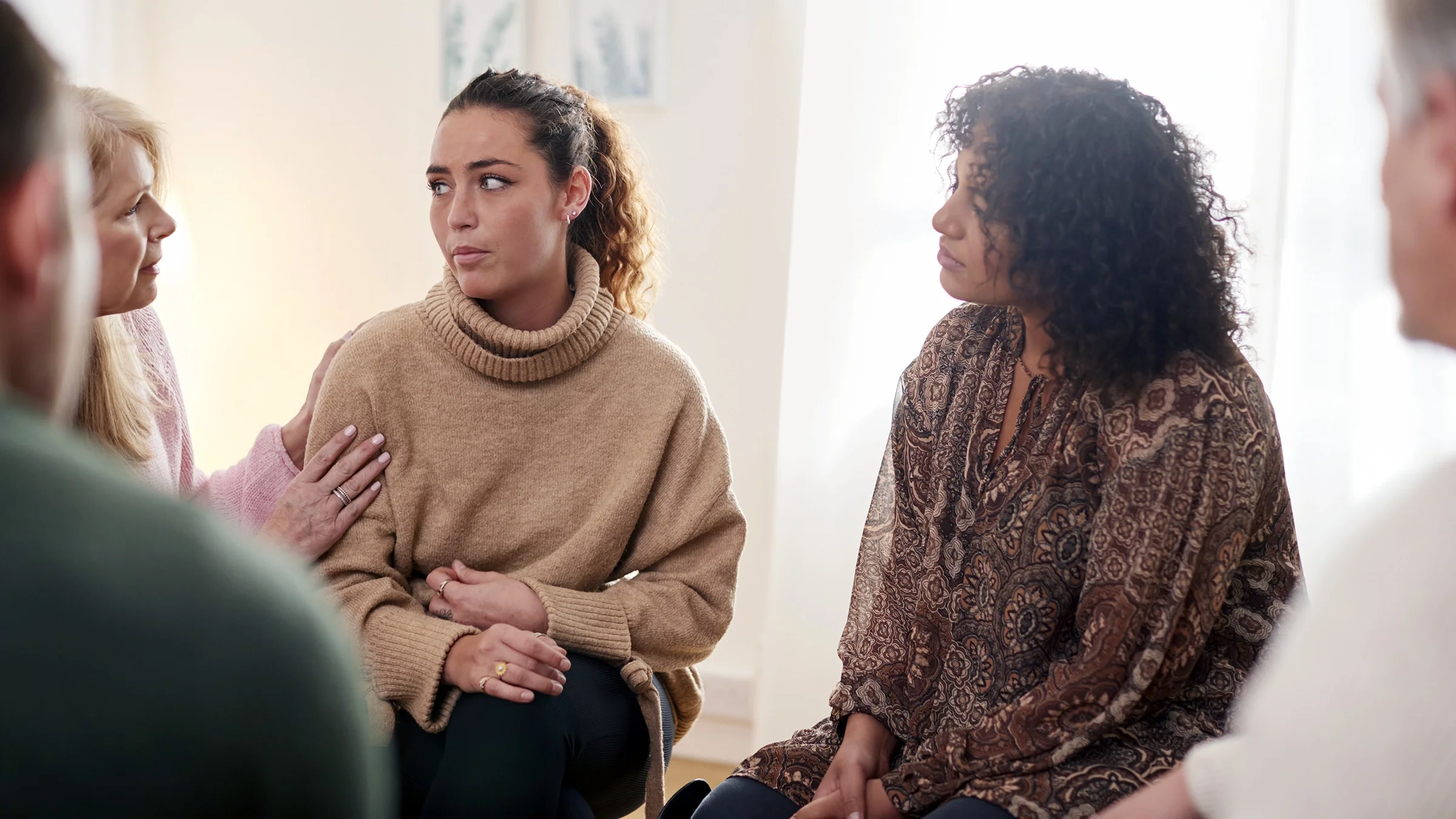 A woman has a discussion with a support group.