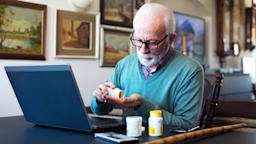 An older man prepares to take his medication.
Slavica/E+ via Getty Images
