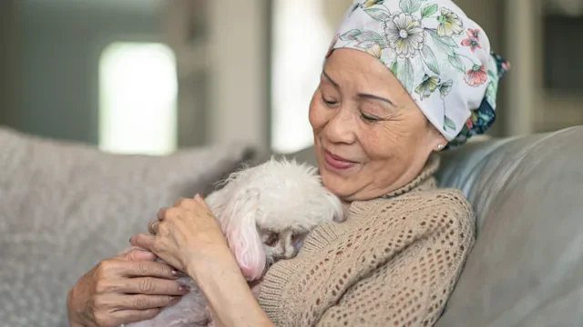 Keytruda: cancer patient hugging poodle 1173647360
