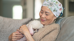 A cancer patient hugging a poodle.
FatCamera/E+ via Getty Images 