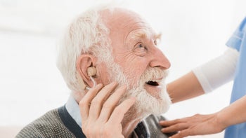 Health: Dementia: older man hearing aids-1163755991