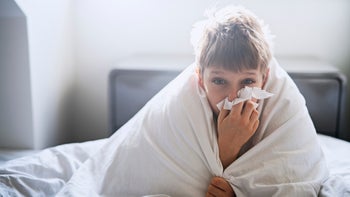 Health: Children's Health: sick boy wrapped in blanket 954912602