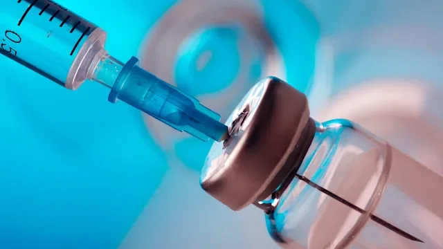peptides: closeup syringe needle and vial 1154747097