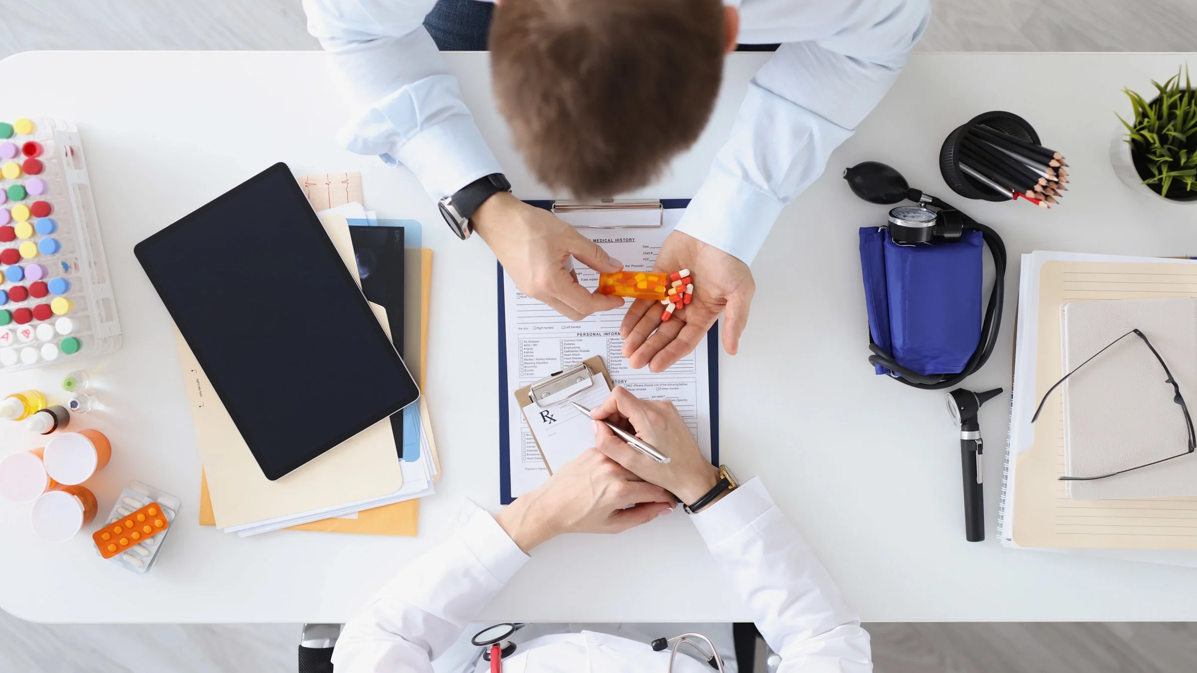 Top view of a doctor prescribing medicine. 