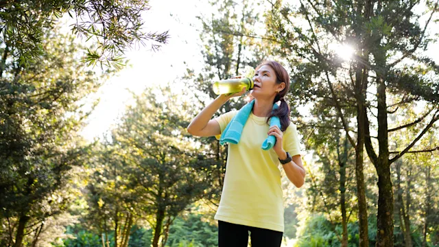 does-vitamin-d-give-you-energy: woman drinking water after outdoor workout 2164261896