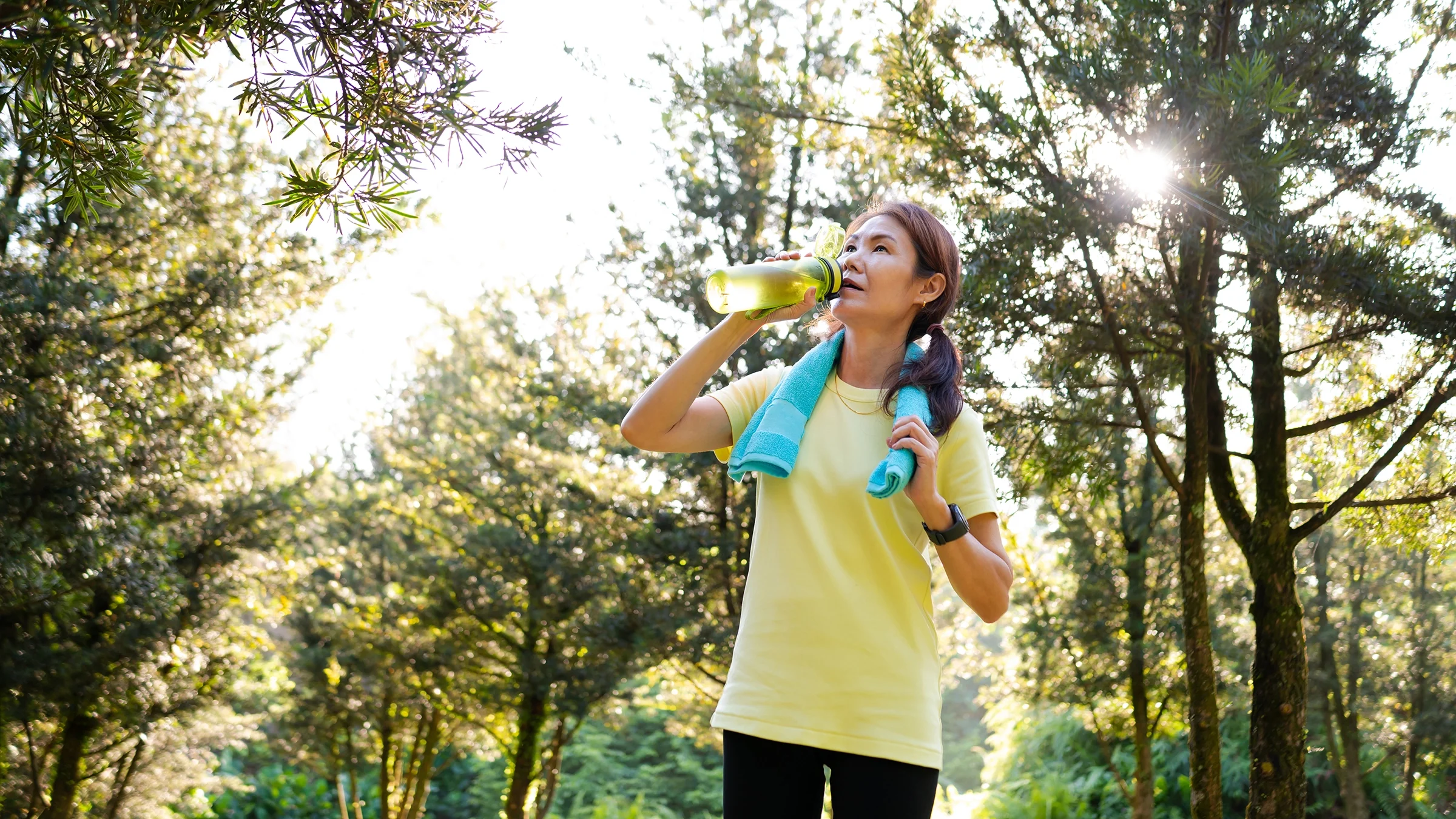 Woman drinking water after an outdoor workout
