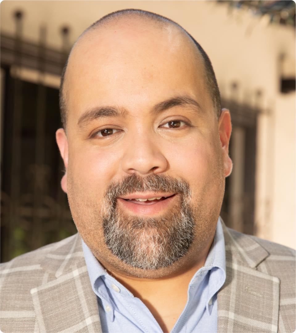 Christian Carrion is pictured in a headshot.