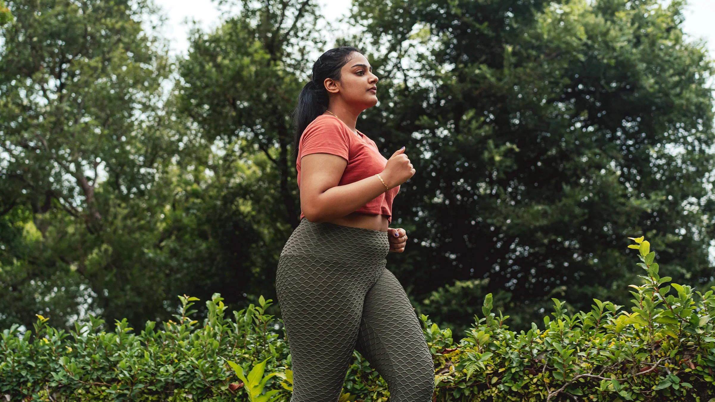 A woman jogs in an outdoor park. Physical activity can help with constipation caused by Ozempic, a medication to treat Type 2 diabetes.