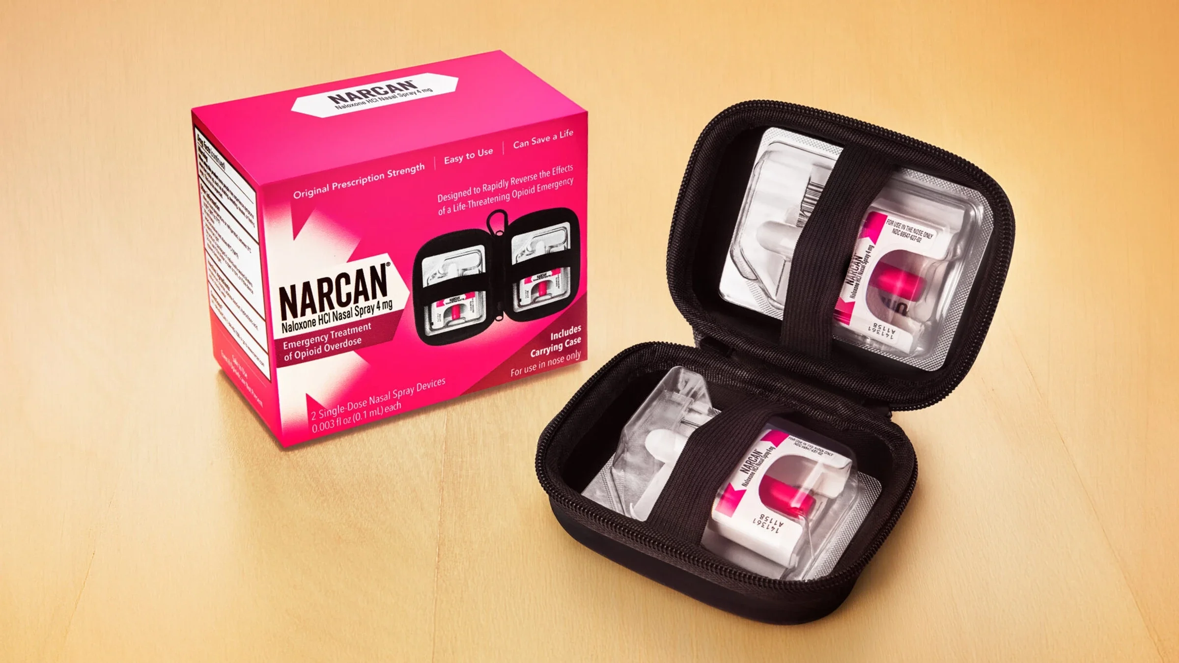 The image shows Narcan product on a wooden surface.