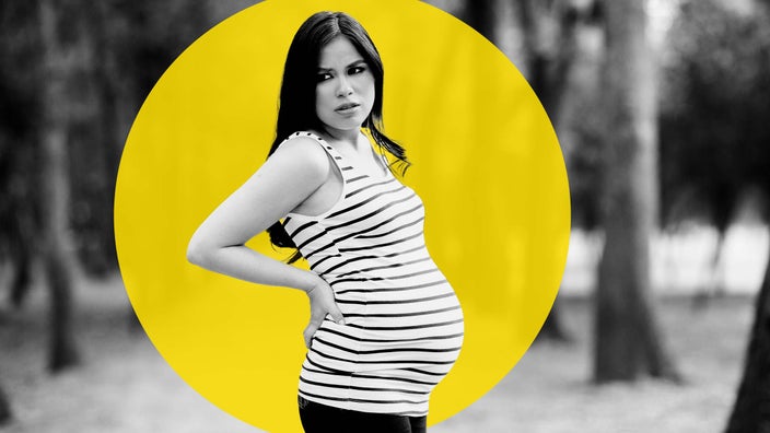 Black and white portrait of a pregnant woman with back pain. She is standing outside. There is an added yellow graphic circle behind her.