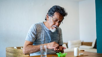 atenolol: man taking medication at home 1311708706