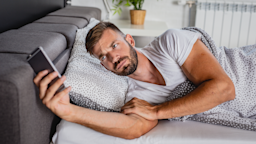 A man uses a mobile phone in bed.
blackCAT/E+ via Getty Images