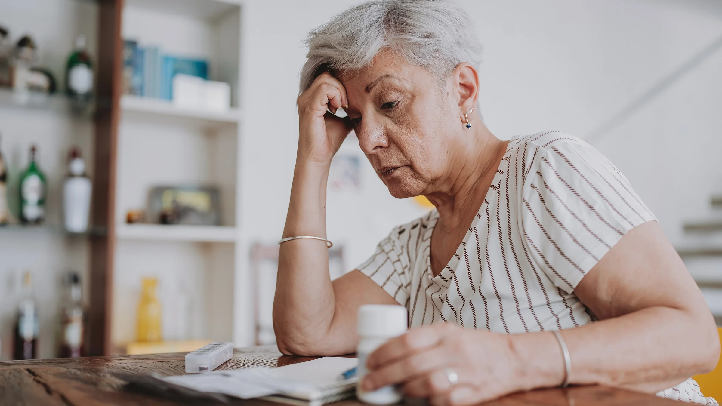 Senior woman reading about medical prescription.