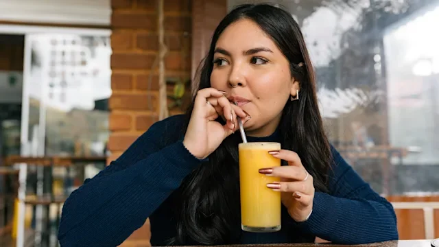 Tirzepatide: woman drinking orange juice 2227306055