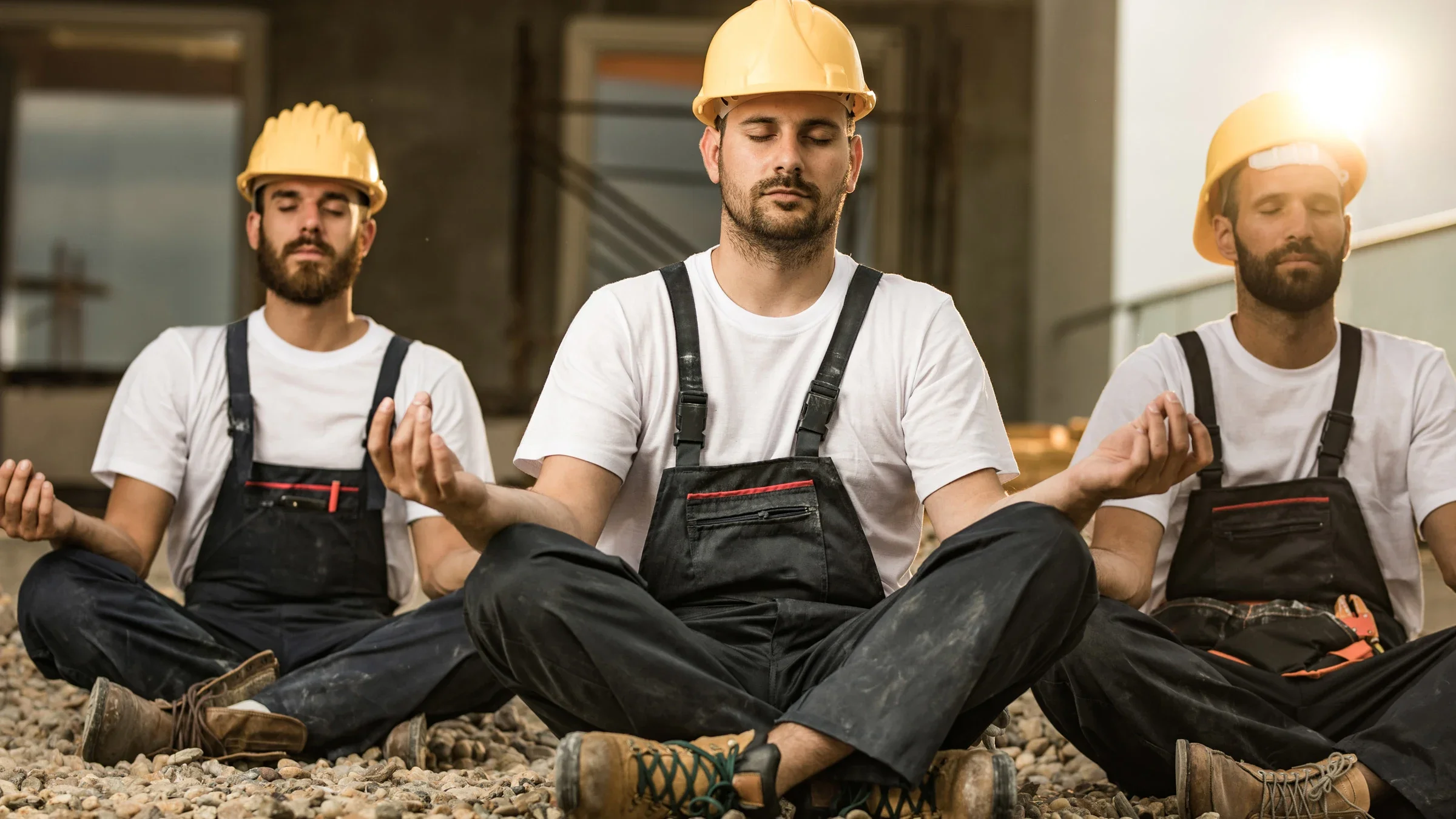 Mental health: Men: construction workers meditating 1129347214