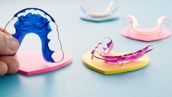Health: Dental care: dental retainer on blue surface 1053349840