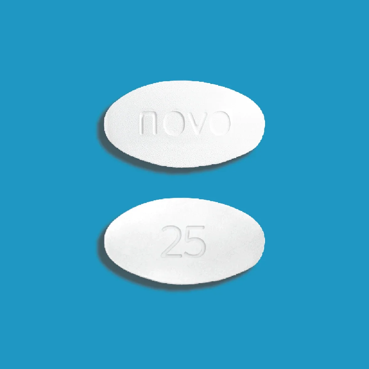 Blue background with white oblong Novo Nordisk Wegovy 25mg pill, front and back.