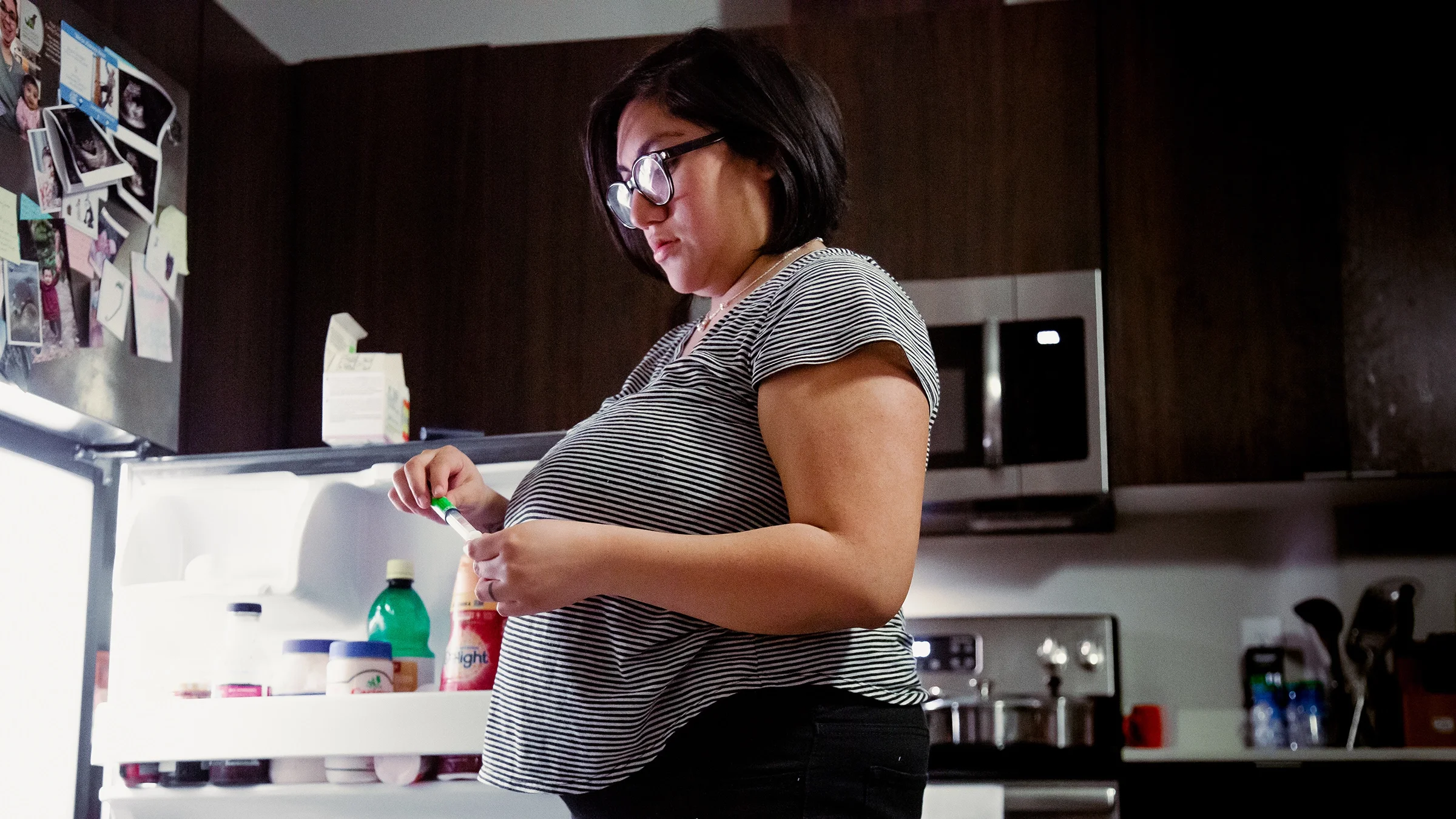 Woman prepping her stomach injection. 