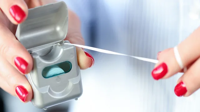 Environmental: Dental care: closeup dental floss 1299963560