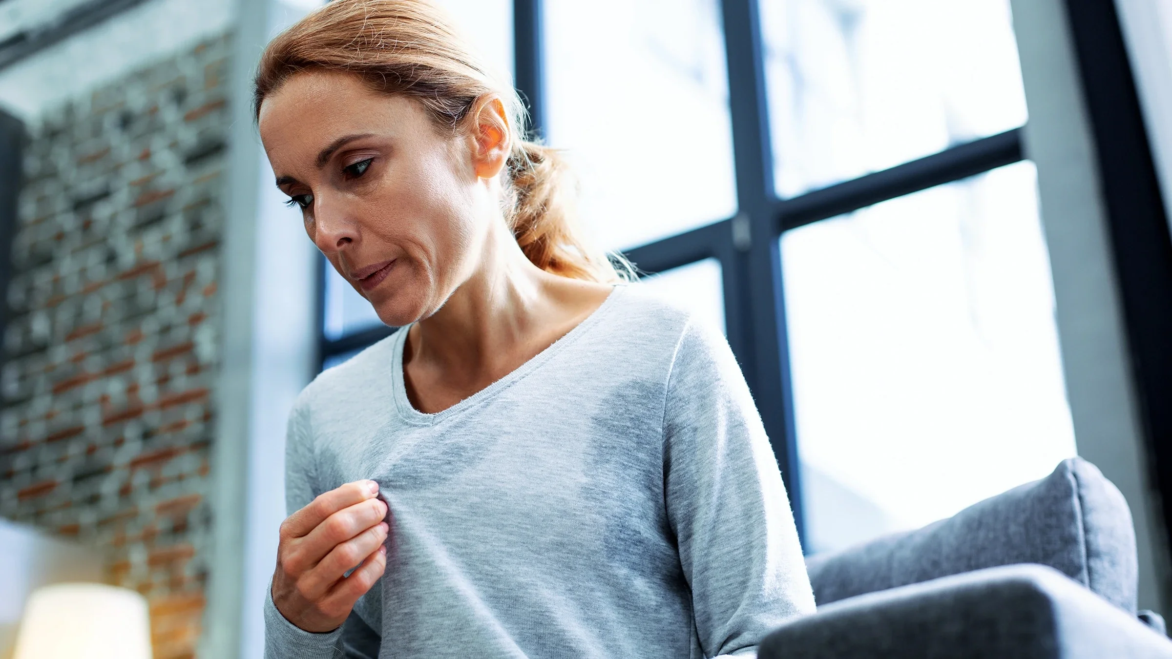 Woman experiencing hot flashes