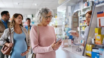 Personal finance: Pharmacy: woman paying with her phone 2242851166