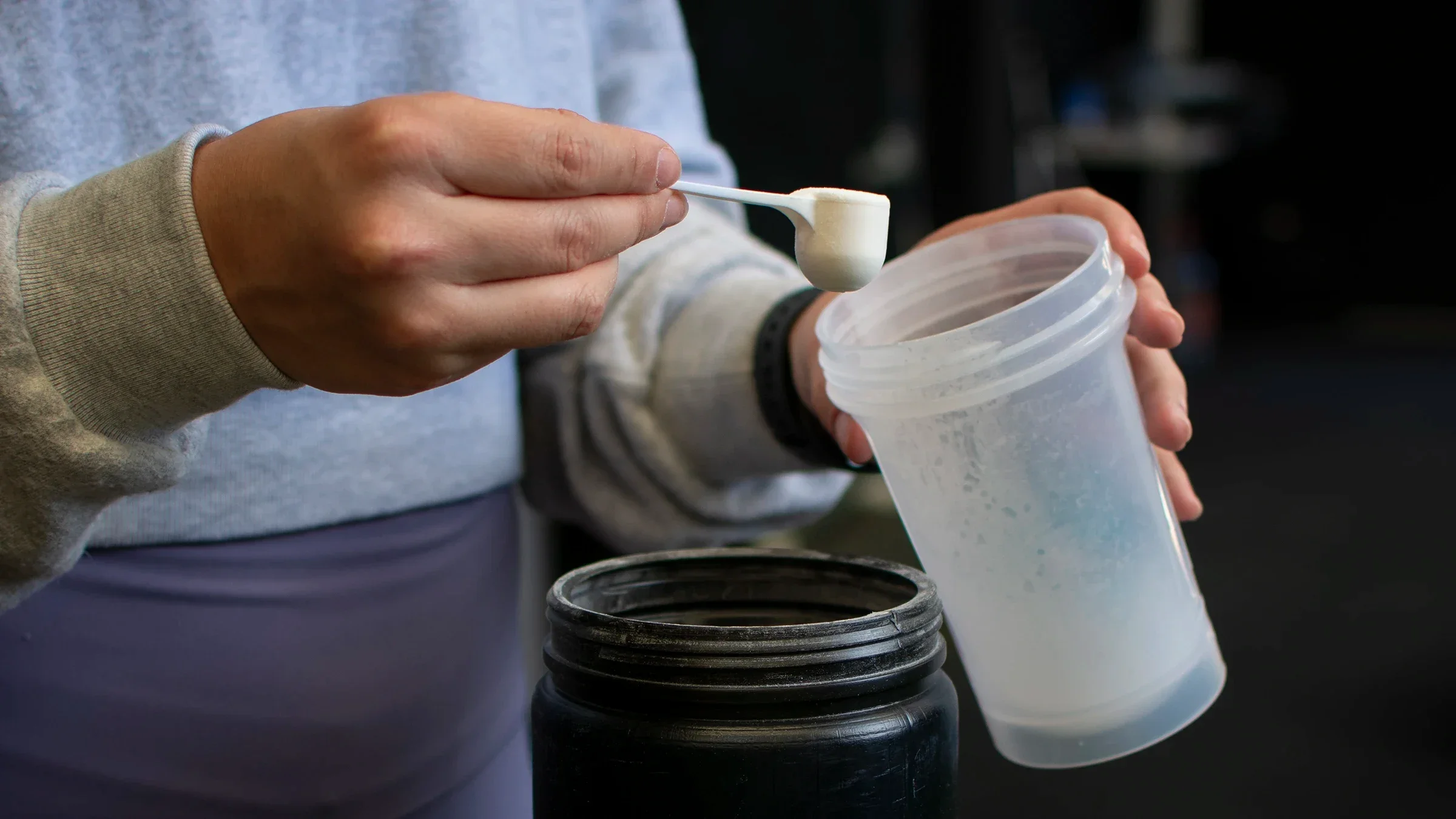 Close-up hands pouring a supplement scoop into a shaker
Edgar BJ/iStock via Getty Images Plus