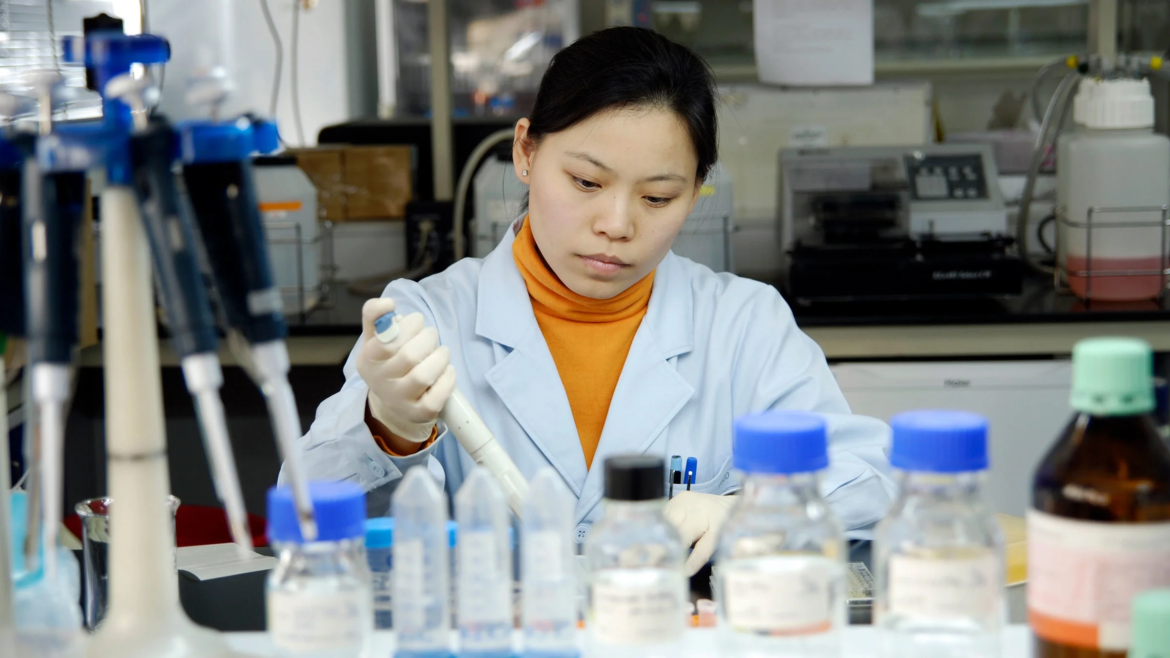 A woman performs research in a lab.
