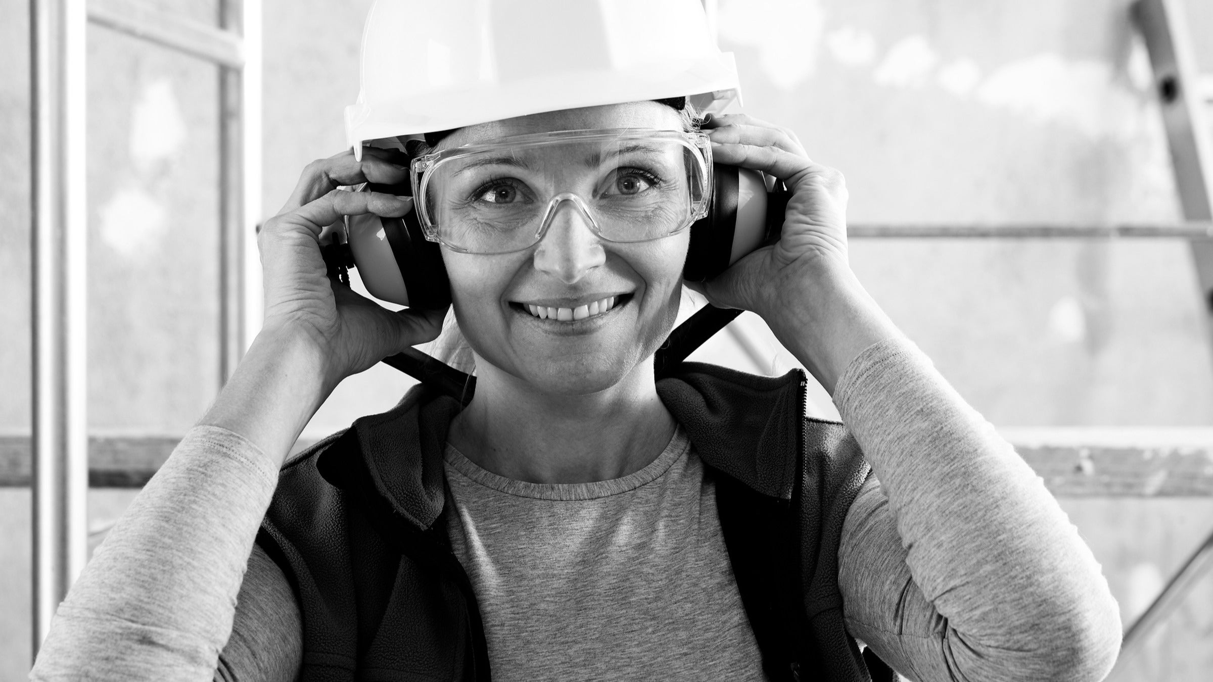 ear-health: woman: worker: black and white construction worker ear protection 1213044961