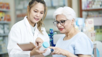 Benadryl: Dementia: pharmacist patient discussing pill bottle 1448940522