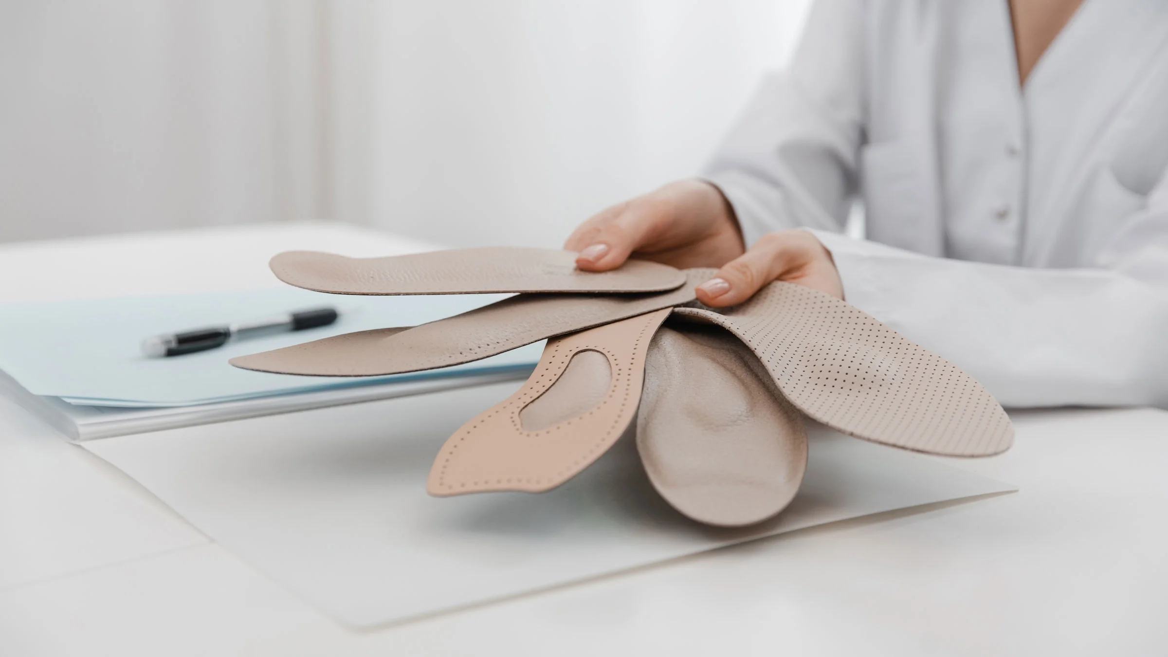 Doctor holding orthopedic insoles