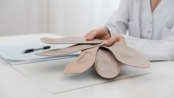 Health: Musculoskeletal conditions: doctor holding orthopedic insoles 1367349823