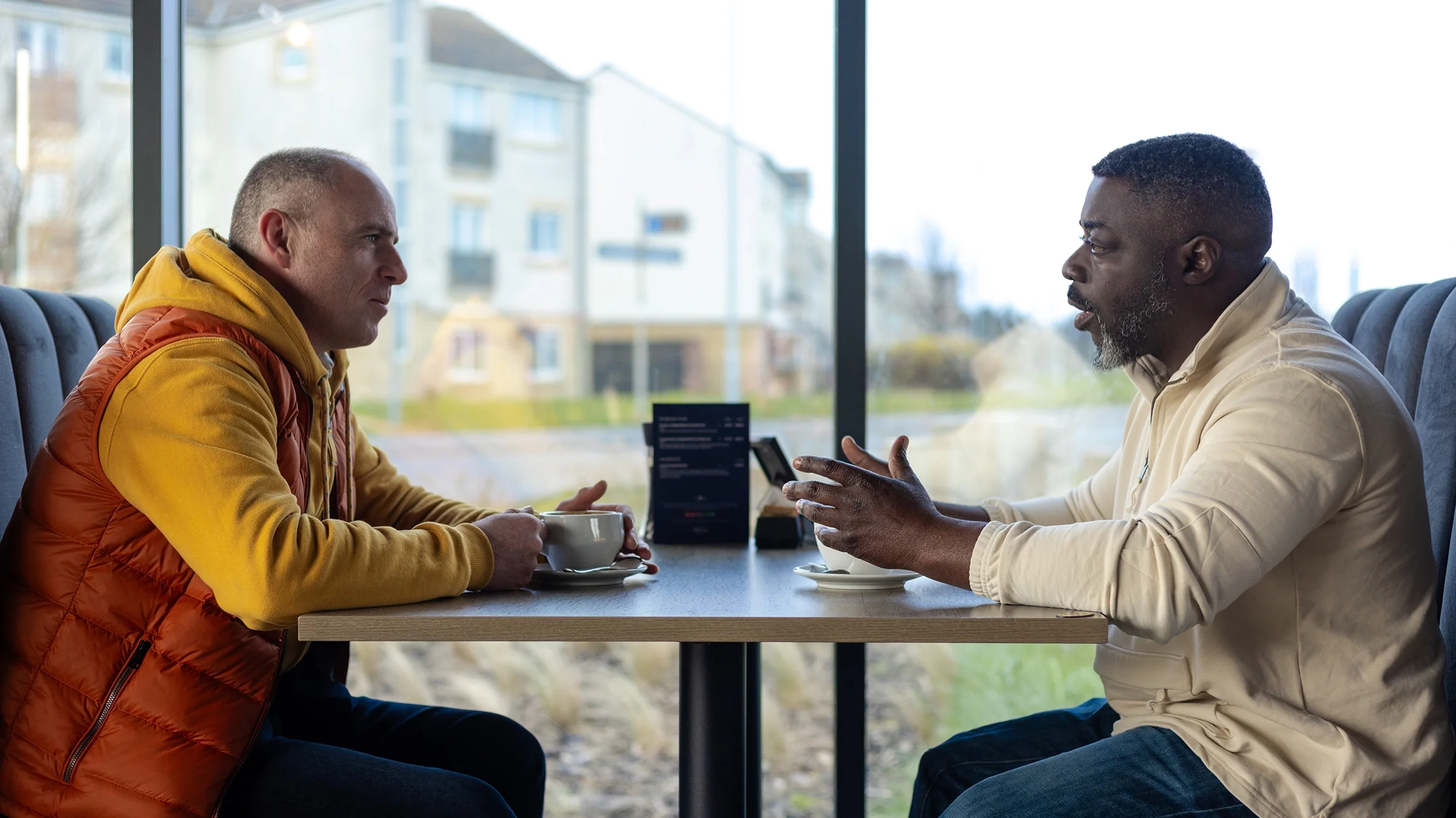 Two friends talking over a cup of coffee