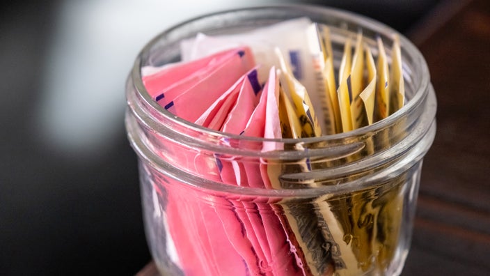 Close-up of a jar of artificial sweetener packets.