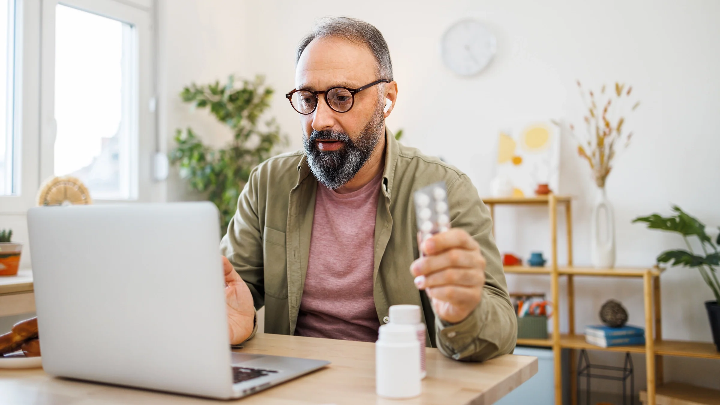 A man is speaking to a healthcare provider about his medication during a telehealth appointment.