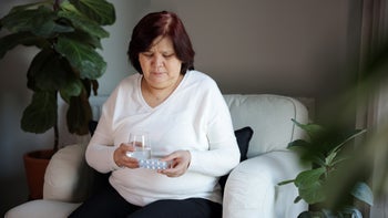 rosuvastatin: woman taking daily medication 1988351010
