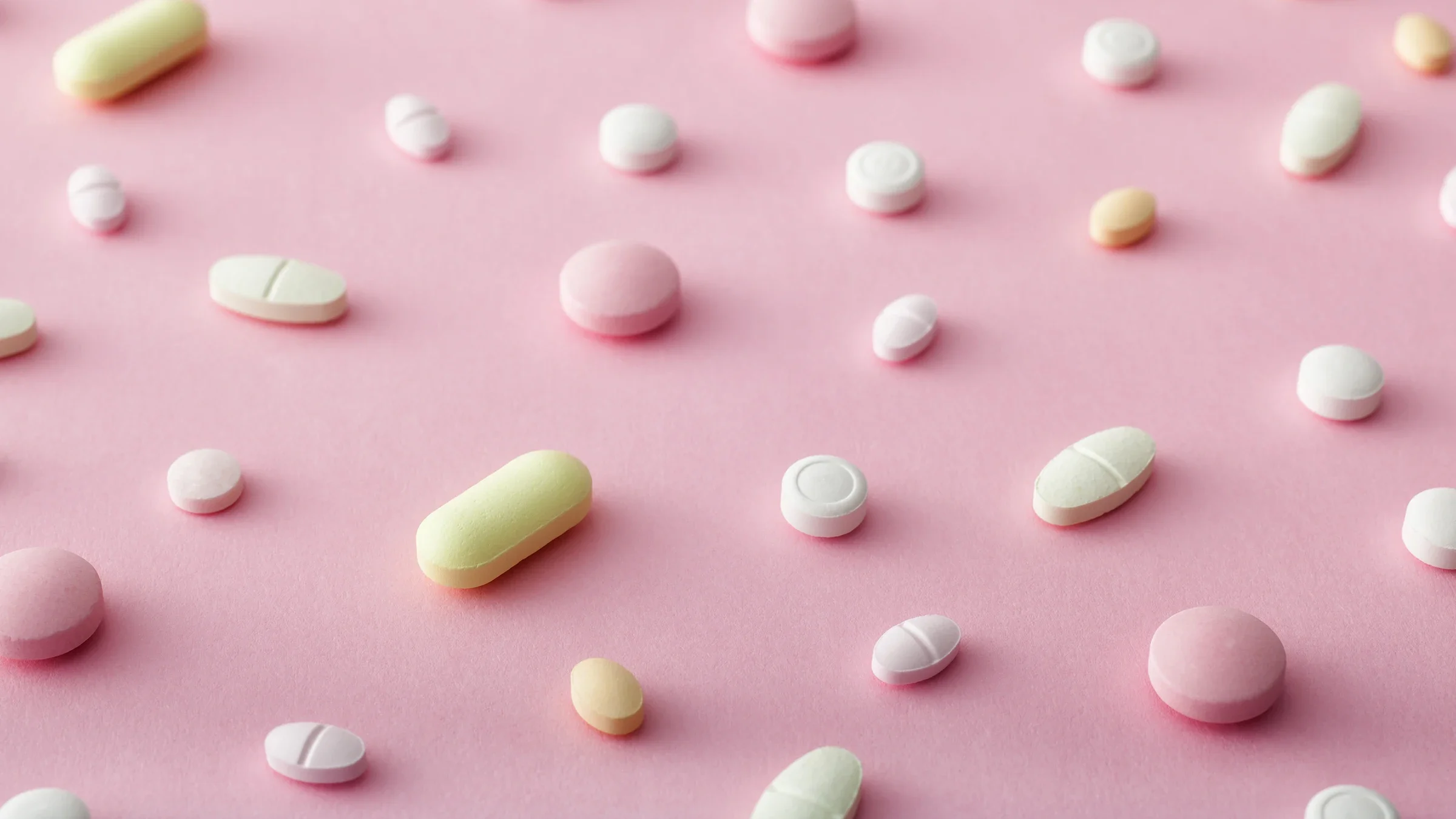Scattered pills on a pink background.
Altayb/iStock via Getty Images Plus

