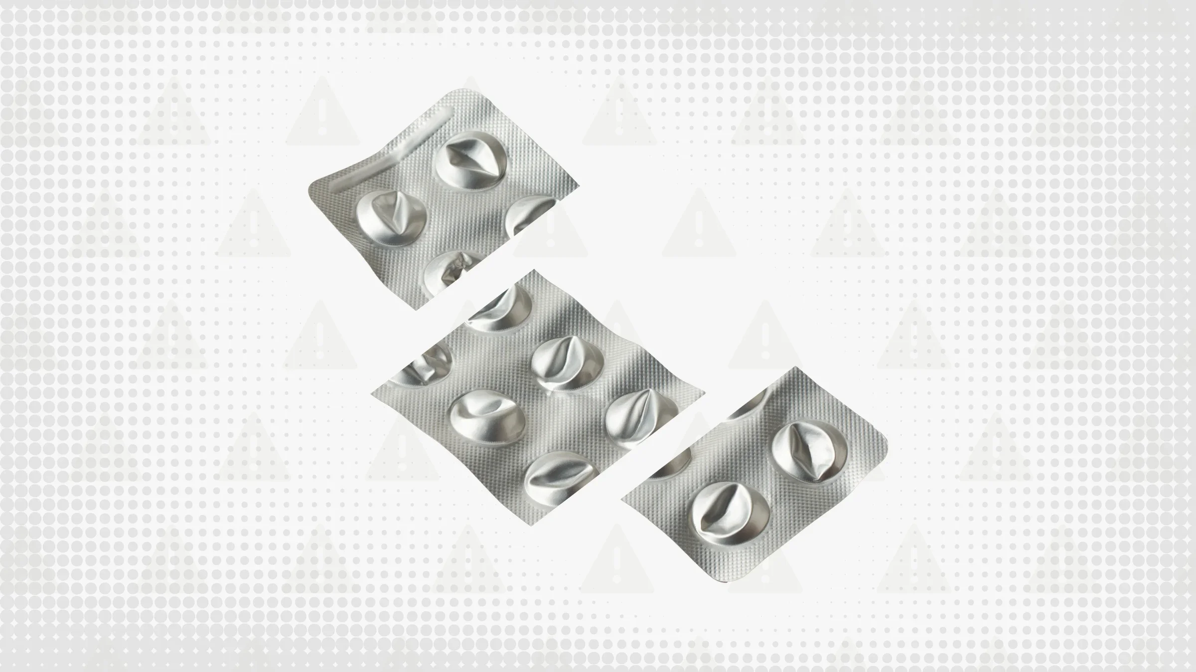 Gray background with texture and warning sign pattern. In the center is an empty, punched-out blister pack for round pills, cut into thirds.  
GoodRx Health