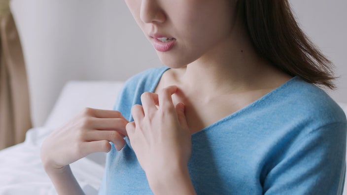 Cropped shot of someone scratching their chest area.