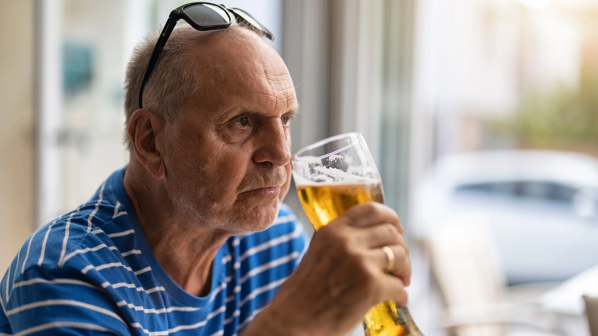 A man drinks a pint of beer.
