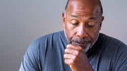 A man coughs into a closed fist. 
pixelheadphoto/iStock via Getty Images Plus