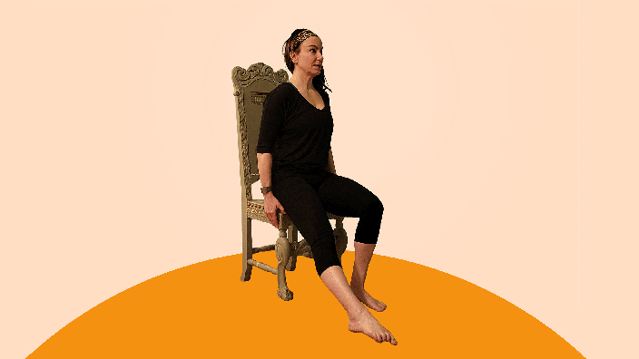 A woman does ankle ABCs exercises on a chair.