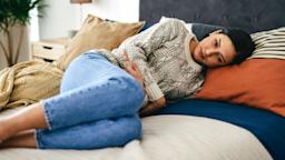 A person experiencing stomach pain in bed.
Charday Penn/iStock via Getty Images Plus