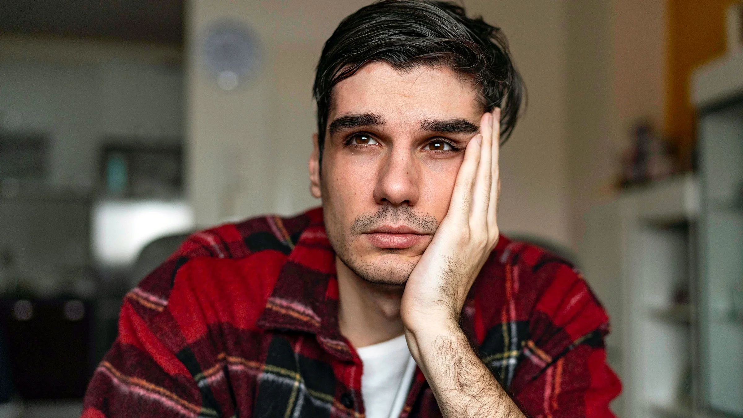 A man stares into the distance. People with Crohn’s disease, a chronic bowel condition, can experience depression due to the stress the condition’s symptoms cause.