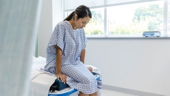 Sexual Health: woman in hospital robe waits for test results 1729780223