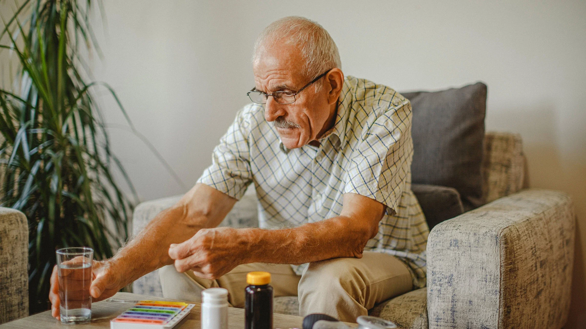 Senior man taking medicine at home.
Dejan Marjanovic/E+ via Getty Images